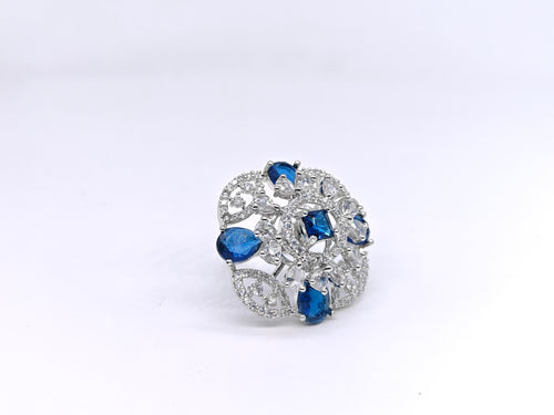 Elegant brooch with blue and clear gemstones on a white background
