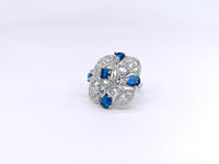 Silver ring with blue gemstones on a white background