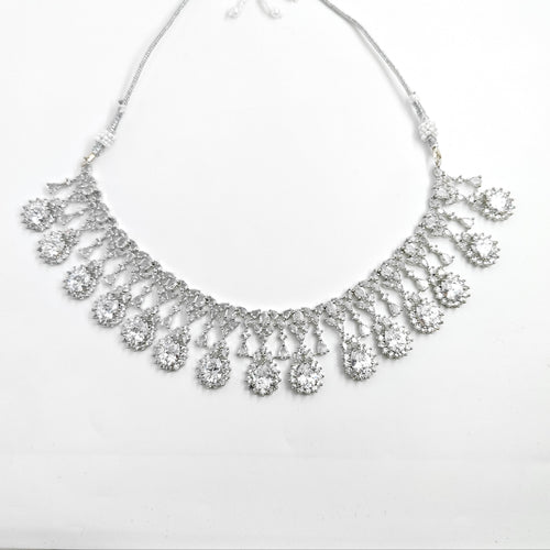 Silver necklace with teardrop-shaped pendants on a white background