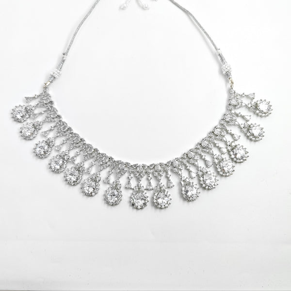 Silver necklace with teardrop-shaped pendants on a white background