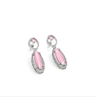 Pair of pink earrings with silver accents on a white background
