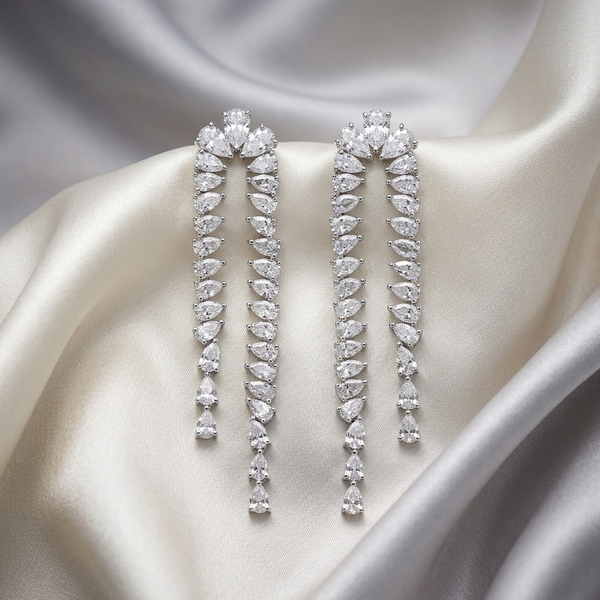 Pair of diamond earrings on a satin surface