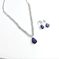 Jewelry set with purple teardrop earrings and necklace on a white background