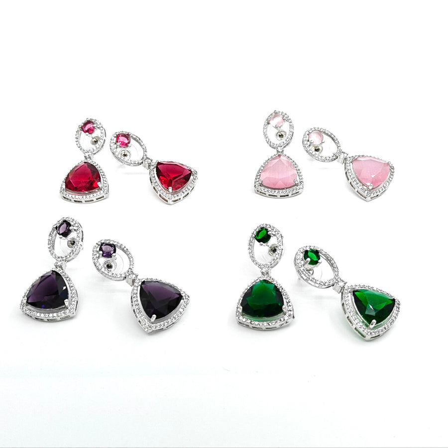 Set of colorful gemstone earrings on a white background