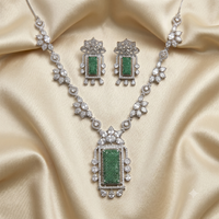 Jewelry set with necklace and earrings on a beige fabric background