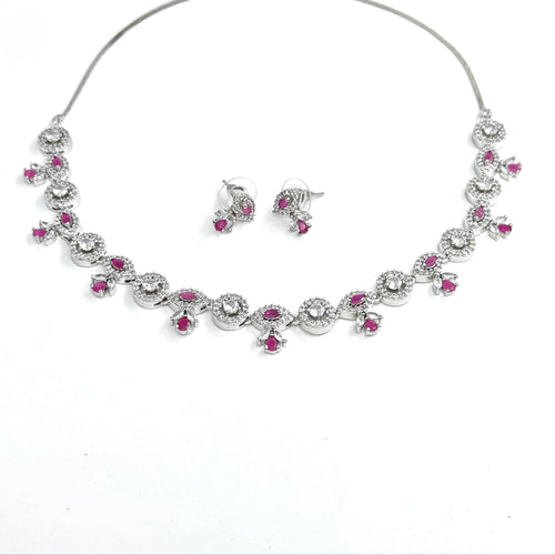 Jewelry set with necklace and earrings featuring pink gemstones on a white background