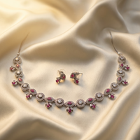 Jewelry set with necklace and earrings on a beige fabric background