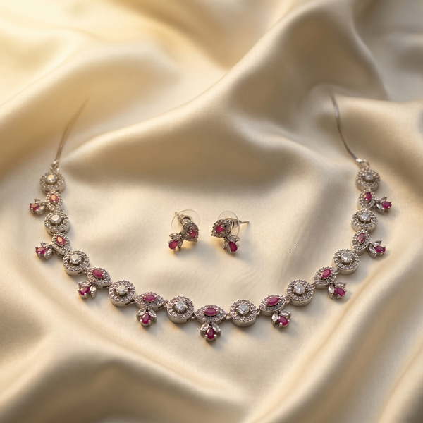 Jewelry set with necklace and earrings on a beige fabric background