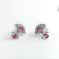 Pair of earrings with pink gemstones on a white background