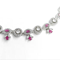 Silver bracelet with pink gemstones on a white background