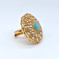 Gold ring with a turquoise stone on a white background
