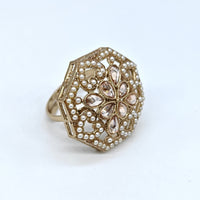 Decorative ring with intricate design on a white background