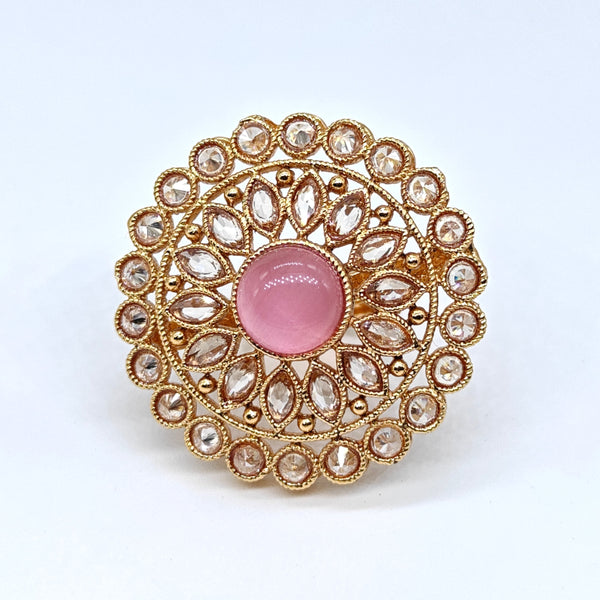 Decorative ring with pink gem and gold detailing on a white background