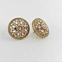 Gold round earrings with gemstone-like embellishments on a light gray background