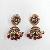 Ornate earrings with red and gold details on a white background