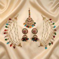 Decorative jewelry set with beads and gemstones on a beige fabric background