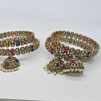 Decorative bangles with jhumkas on a white background
