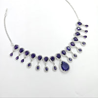 Necklace with blue teardrop-shaped stones on a white background