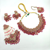 Ornate necklace with matching earrings on a white background