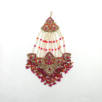 Ornate necklace with red and gold accents on a white background