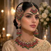 Woman wearing elaborate jewelry set with floral patterns and colorful stones against a blurred background.