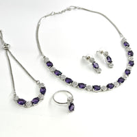 Jewelry set with necklace, bracelet, and earrings on a white background