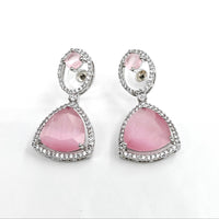 Pair of pink teardrop earrings with silver accents on a white background