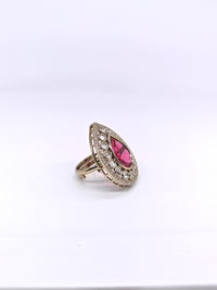 Ring with a pink gemstone and diamond accents on a white background