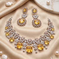 Luxury jewelry set with yellow gemstones on a beige fabric background