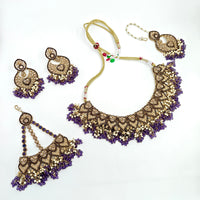 Ornate necklace with matching earrings on a white background