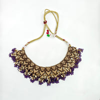 Decorative necklace with purple stones on a white background
