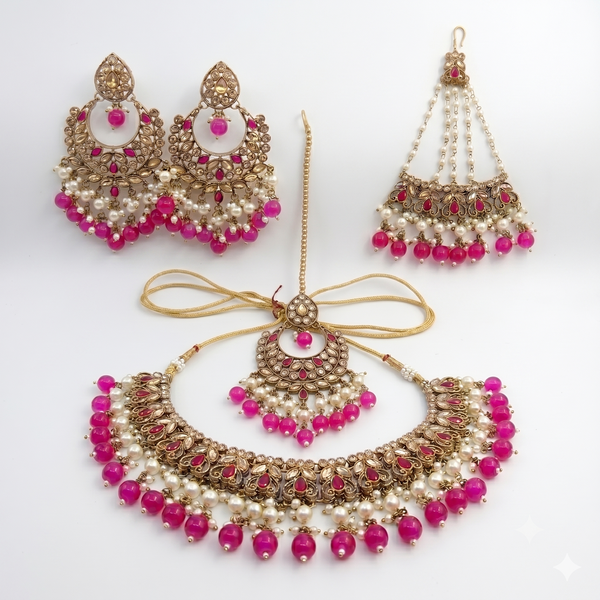 Jewelry set with necklace, earrings, and decorative piece on a white background