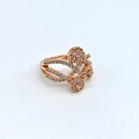 Rose gold ring with gemstones on a white background
