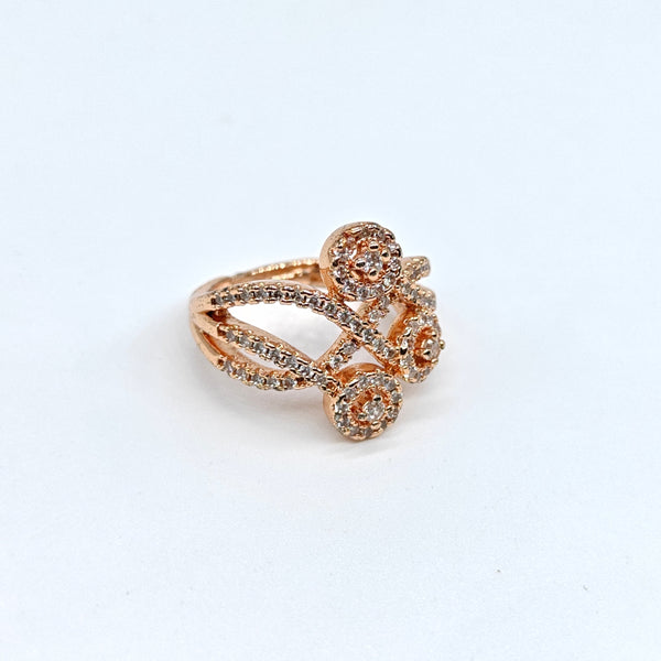 Rose gold ring with gemstones on a white background