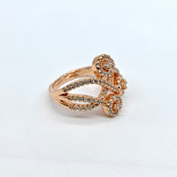 Rose gold ring with gemstones on a white background