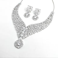 Silver necklace and earrings set on a white background