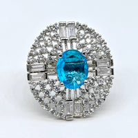 Diamond ring with a blue gemstone on a white background