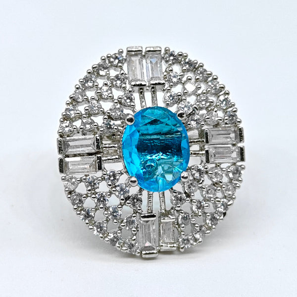 Diamond ring with a blue gemstone on a white background