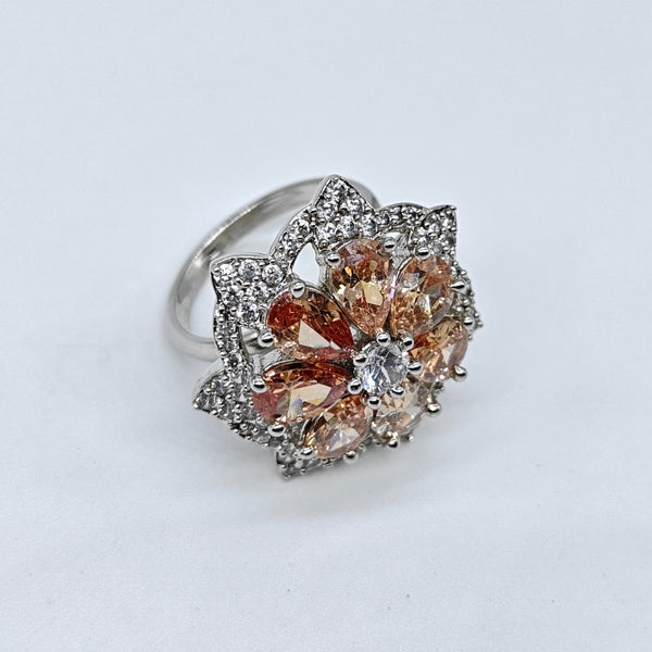 Silver ring with brown gemstones on a white background