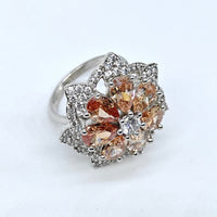 Silver ring with multicolored gemstones on a white background