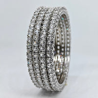 Silver ring with multiple rows of diamonds on a light gray background