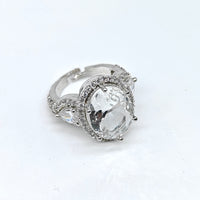 Silver ring with a large clear gemstone on a white background