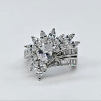 Diamond ring with a star-like design on a light gray background