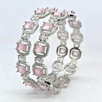 Silver bracelet with pink gemstones on a white background