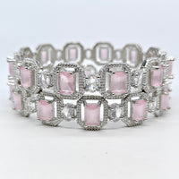 Bracelet with pink gemstones and silver accents on a light gray background