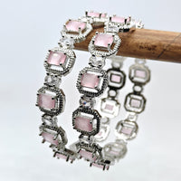 Bracelet with pink gemstones and silver accents on a light gray background