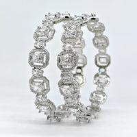 Pair of diamond eternity bands on a light gray background