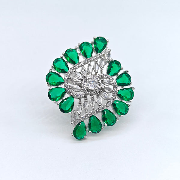 Silver ring with green gemstones on a white background