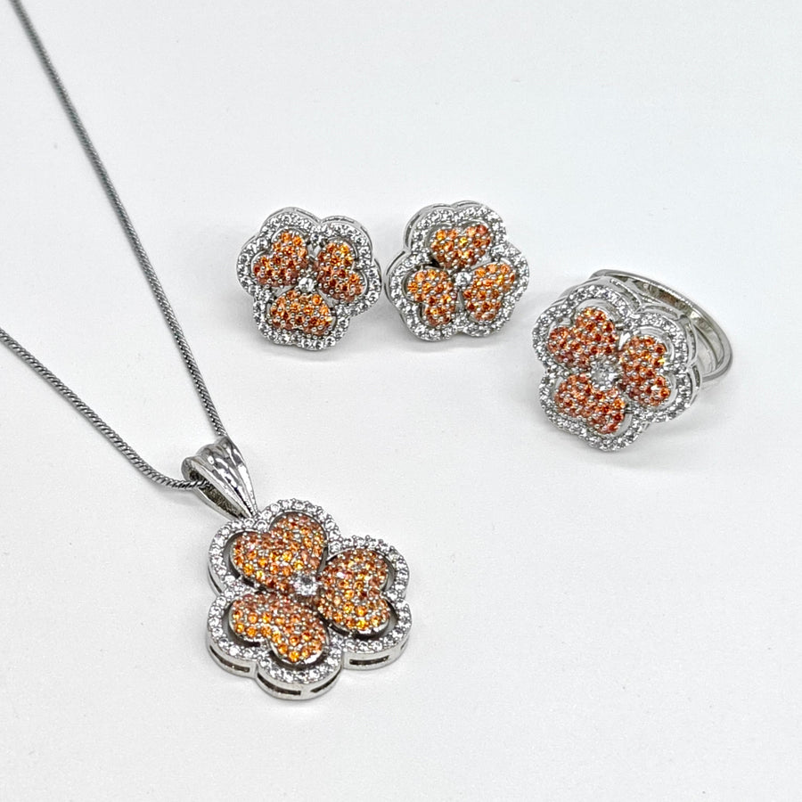 Silver-plated floral American diamond pendant set with matching earrings and ring featuring rose gold flower accents
