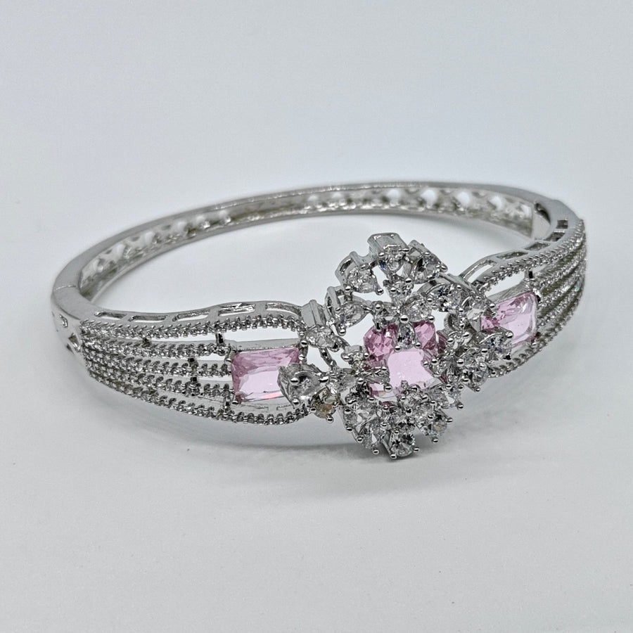 Silver-plated American diamond bracelet with pink baguette stones and sparkling floral centerpiece for women